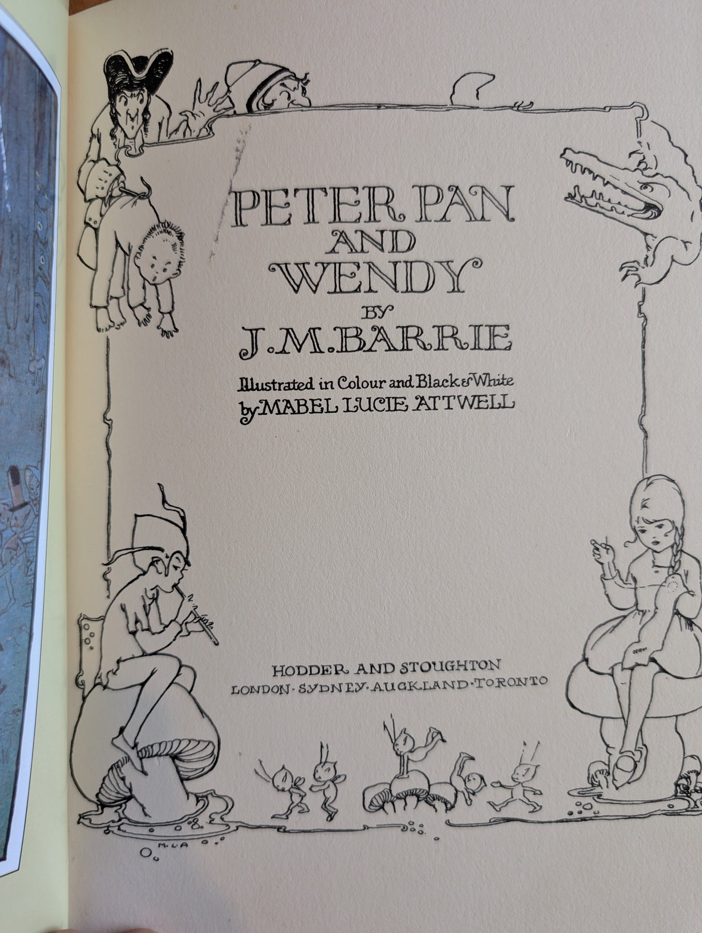 Title page of 'Peter Pan and Wendy' by J.M. Barrie with illustrations on a beige background.