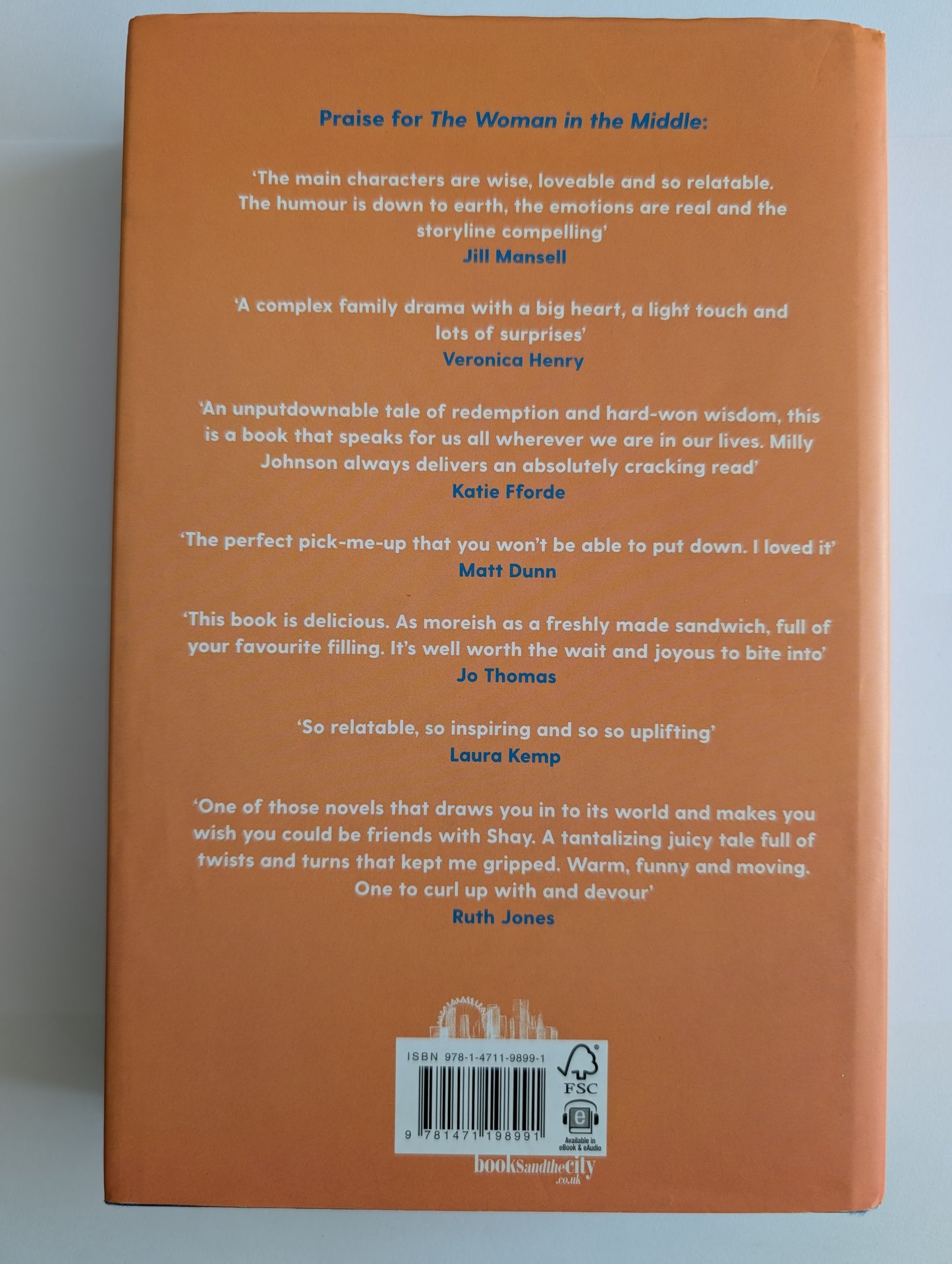 Back cover of a book with text reviews on an orange background
