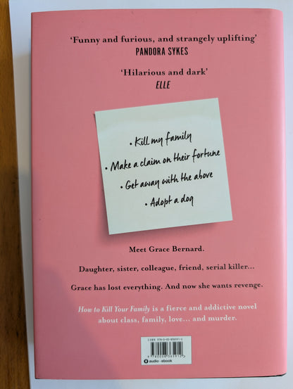 Book cover with a sticky note on a pink background