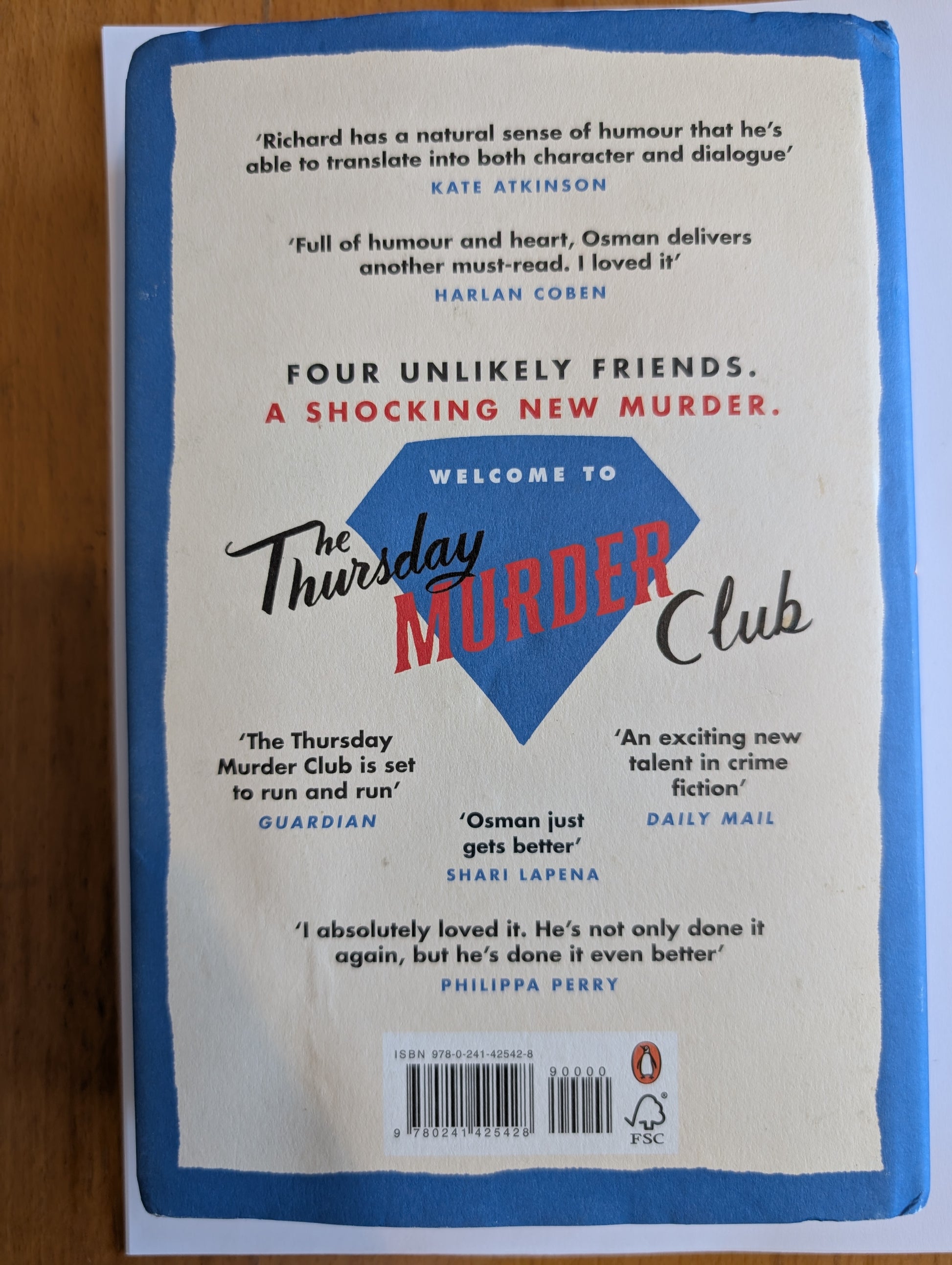 Book cover of 'The Thursday Murder Club' with text and a blue border.