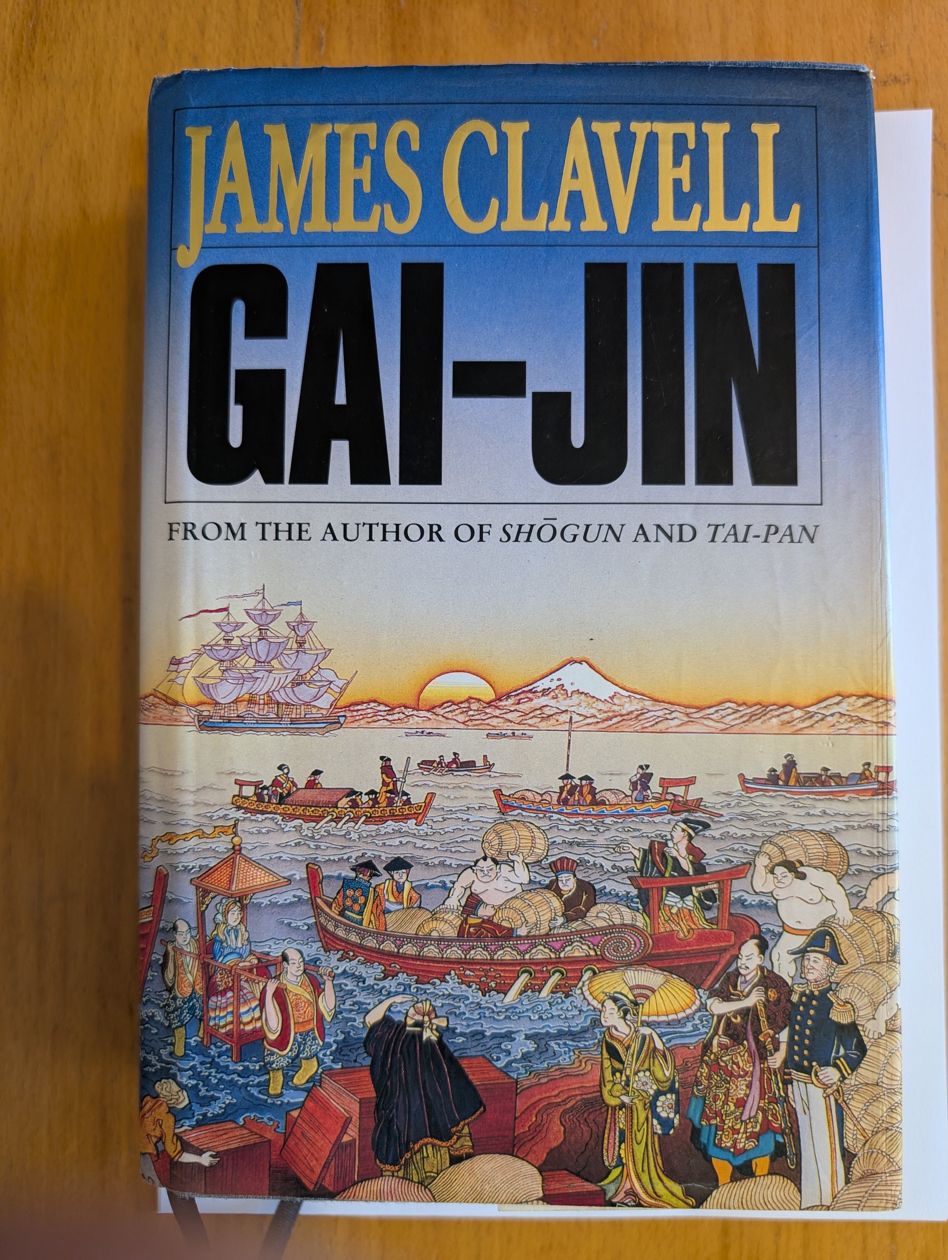 Book cover of 'Gai-Jin' by James Clavell on a wooden surface