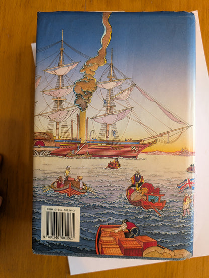 Book cover with a ship illustration on a wooden surface