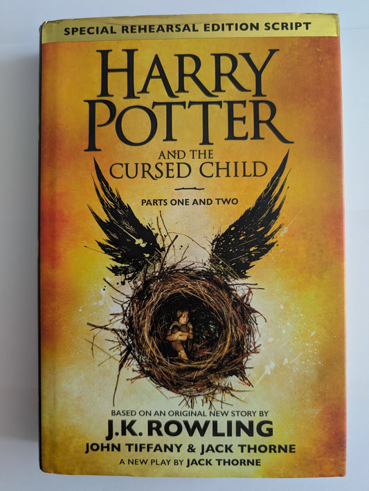 Book cover of 'Harry Potter and the Cursed Child' with a nest and feather design on a yellow background.