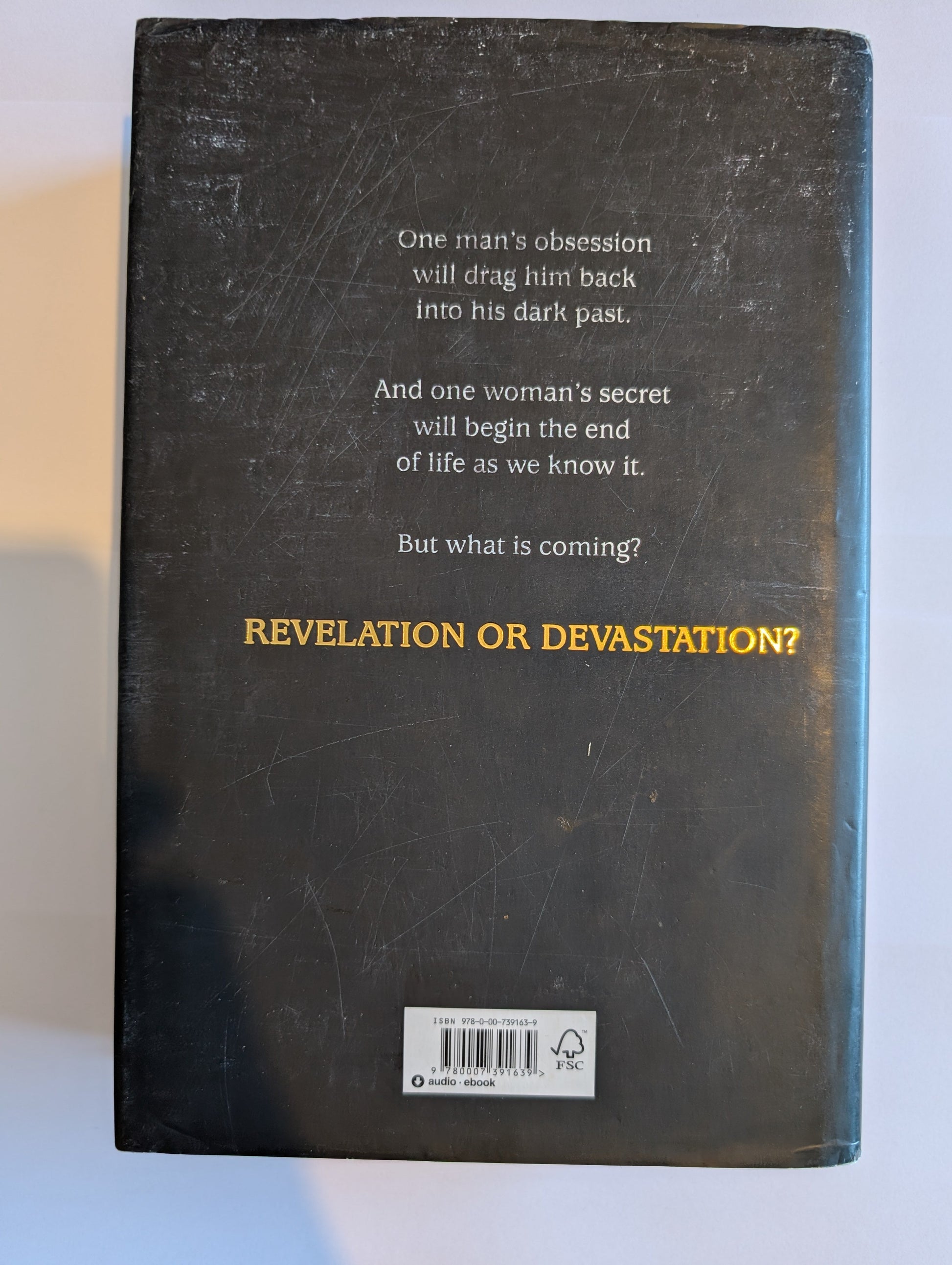 Back cover of a book with text and a barcode on a white background