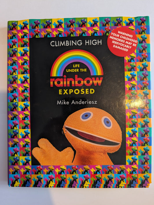 Book titled 'Climbing High Under the Rainbow Exposed' with colorful cover design.