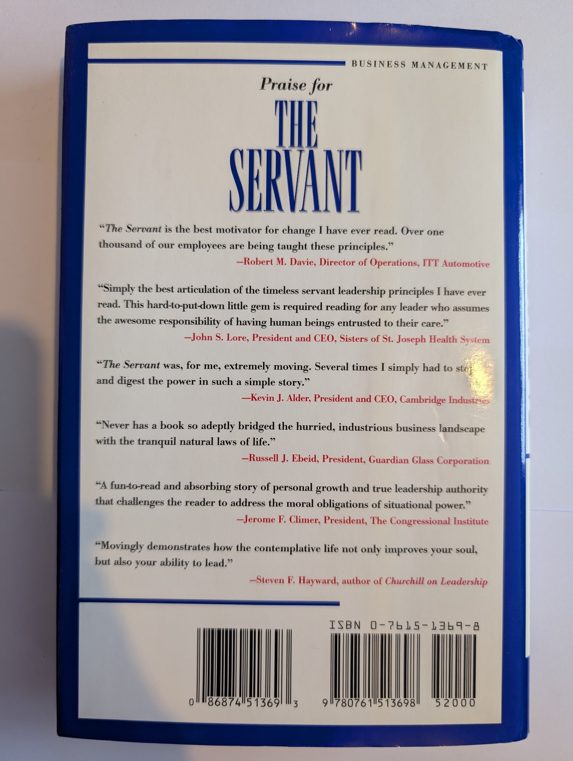 Back cover of a book titled 'The Servant' with praise quotes and a barcode.