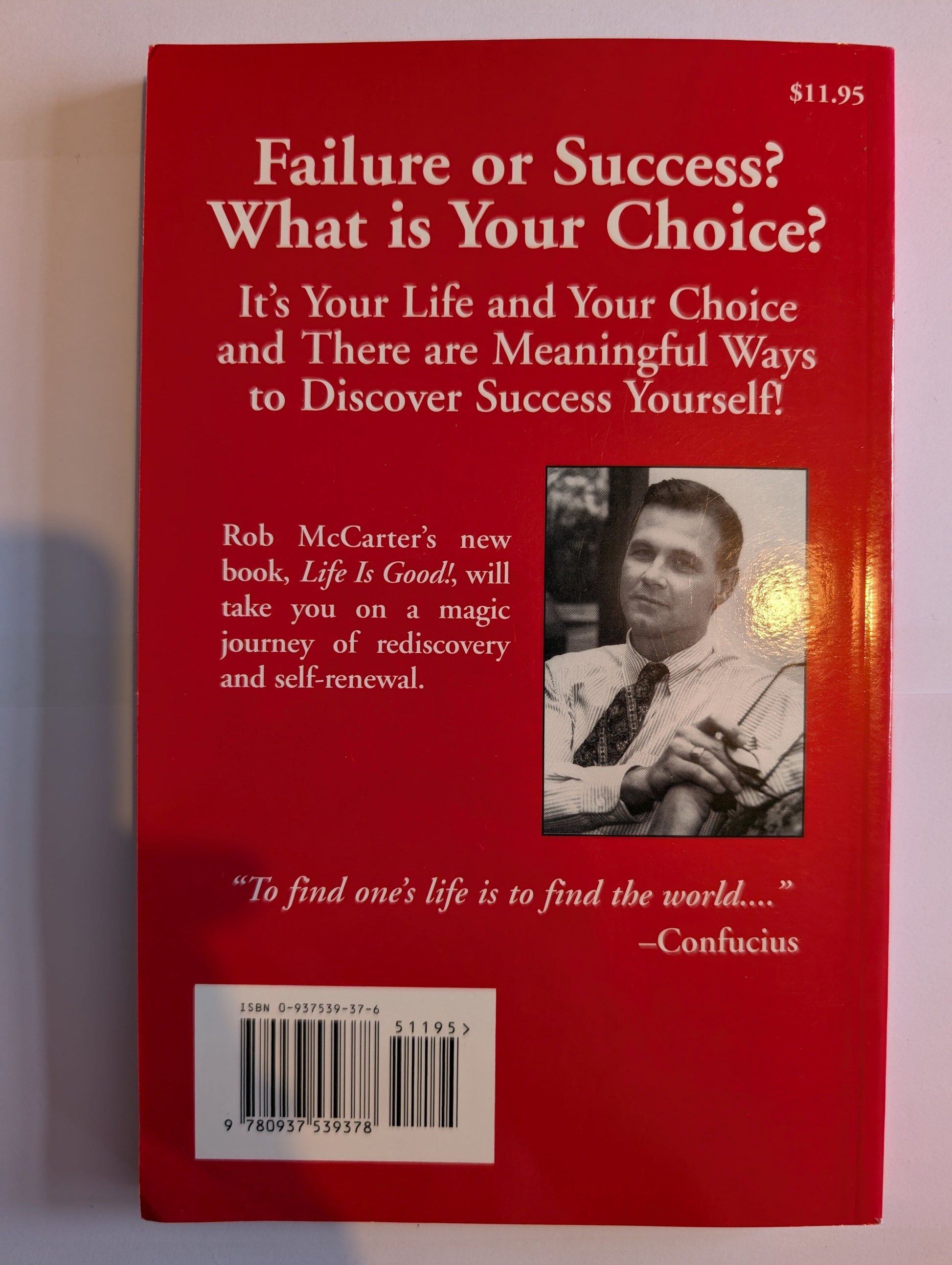 Red book cover with text and a photo of a person on a white background