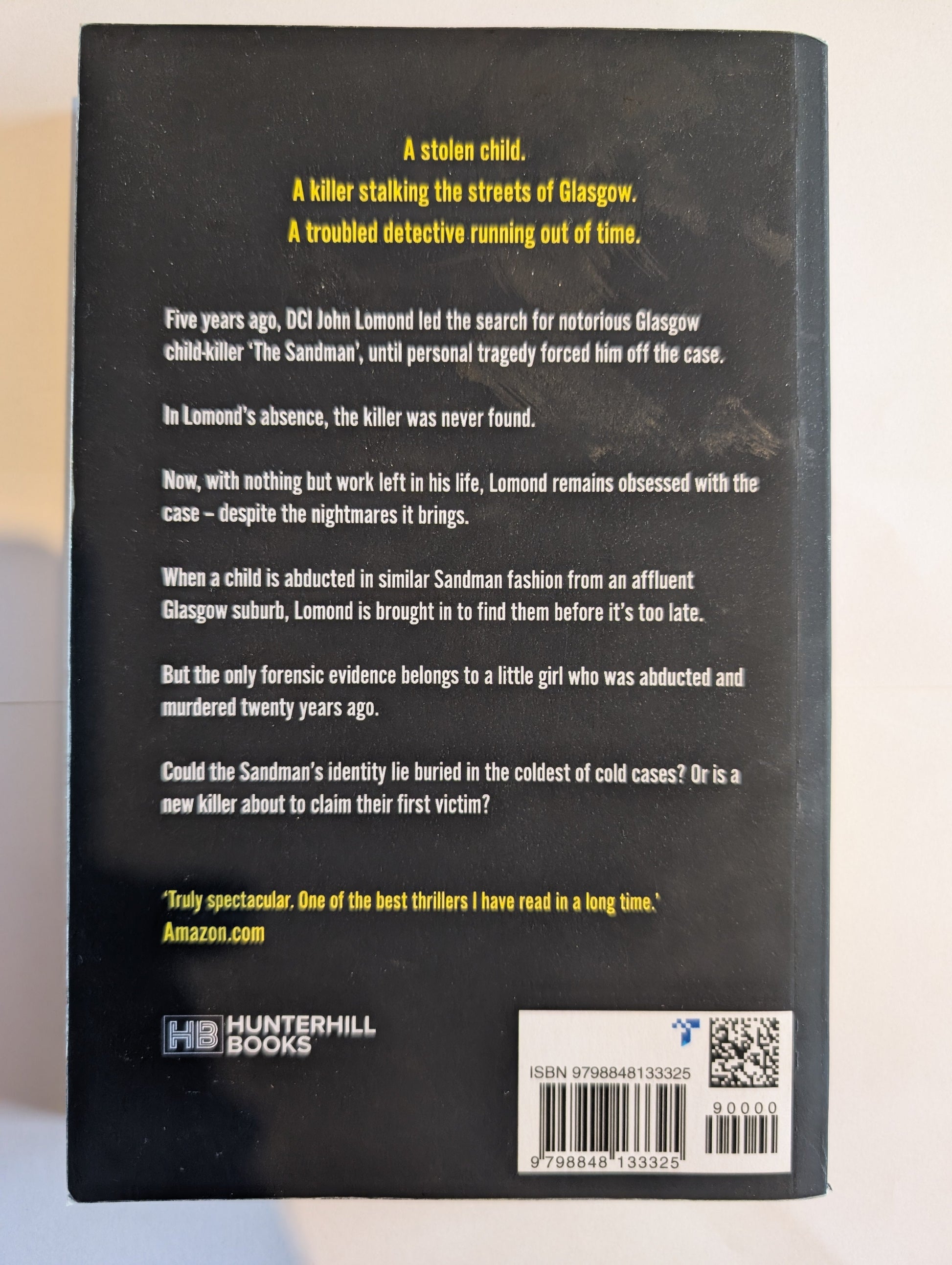 Back cover of a book with text and a barcode on a light background