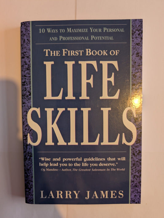 Book titled 'Life Skills' by Larry James on a reflective surface